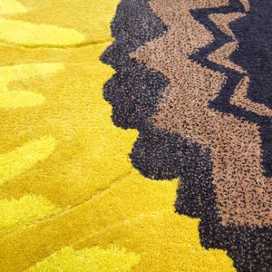 IN-108 Hand Tufted Sunflower Woolen Carpet for Floor Decor, Cozy Home,Bedroom, Courtyard, Living Room, Kids, Cabin, Bedroom, Reading Nook.
A vibrant sunflower-shaped wool rug handcrafted in rich yellow and brown tones, featuring realistic petal textures and a plush wool surface. Displayed in a bright minimalist room with indoor plants, natural sunlight, and a wooden bench, this handmade rug adds a cheerful botanical touch and cozy warmth to any modern living space.
