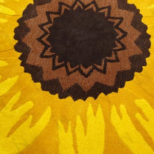 IN-108 Hand Tufted Sunflower Woolen Carpet for Floor Decor, Cozy Home,Bedroom, Courtyard, Living Room, Kids, Cabin, Bedroom, Reading Nook.
A vibrant sunflower-shaped wool rug handcrafted in rich yellow and brown tones, featuring realistic petal textures and a plush wool surface. Displayed in a bright minimalist room with indoor plants, natural sunlight, and a wooden bench, this handmade rug adds a cheerful botanical touch and cozy warmth to any modern living space.