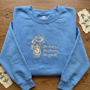 Embroidered Lantern Sweatshirt, Cardan Quote Bookish Crewneck, Be wary Be clever Be good, One Dark Window Highfell Light Gift