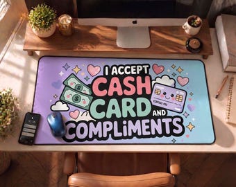 May include: A rectangular desk mat with a gradient purple and blue background. The mat features the text "I ACCEPT CASH CARD AND COMPLIMENTS" with illustrations of cash, a credit card, hearts, and stars. A phone and mouse are visible.