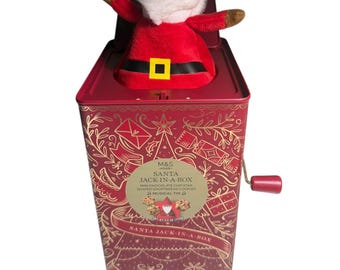 Nova caixa de música M&S Papai Noel Jack-in-a-Box em lata recheada.