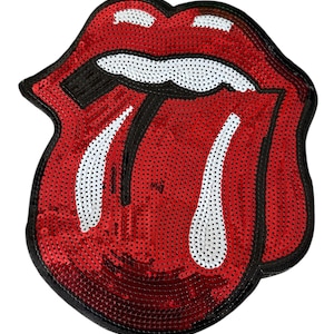 May include: A red sequined lips patch with white teeth and a black outline. The patch is a stylized design of a mouth with the tongue sticking out. The sequins give the patch a shiny appearance.