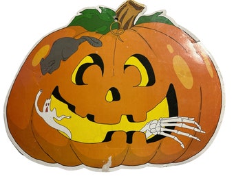 May include: A large orange pumpkin with a carved jack-o'-lantern face. A small grey mouse is climbing on the pumpkin, and a white ghost and a skeletal hand are peeking out from the mouth.