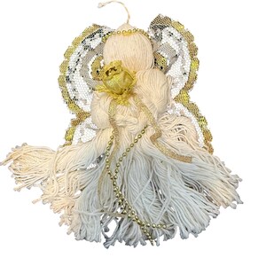 May include: A handmade angel ornament crafted from cream-colored yarn, featuring gold accents. The angel has yarn hair, a gold rose, and gold beaded accents. The wings are made of white lace with gold trim. A loop is attached for hanging.