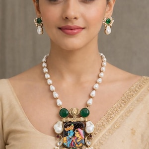 May include: A pearl necklace and matching earrings set. The necklace features a pendant with a colorful painting of two figures, green gemstones, and a gold-colored frame. The earrings have a similar design with green gemstones and pearls.