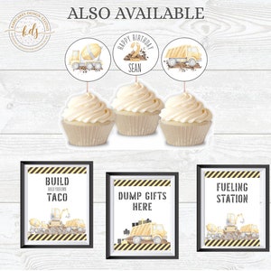 May include: Construction themed party decorations with three yellow cupcakes topped with construction vehicle cupcake toppers. Three printable signs with black frames and yellow and black striped borders read "Build Your Own Taco", "Dump Gifts Here", and "Fueling Station".