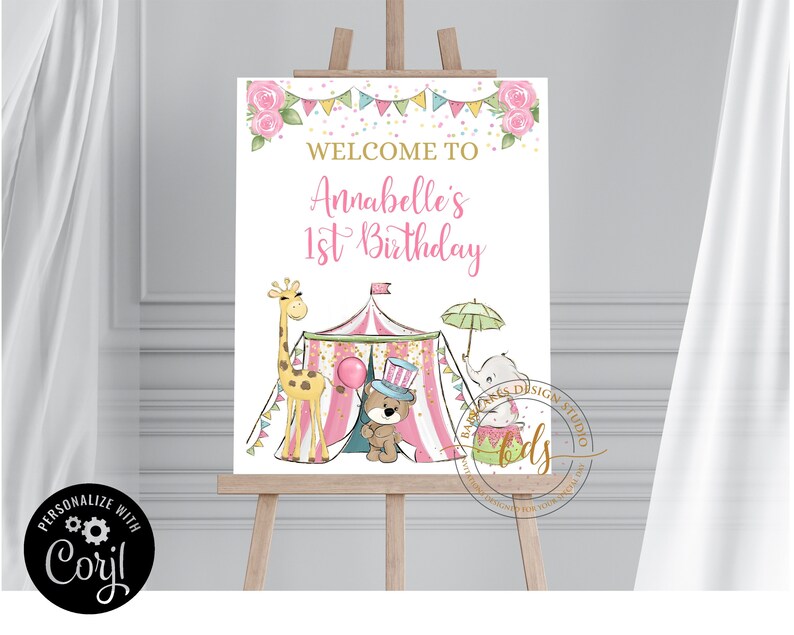 May include: A pink and white welcome sign for a first birthday party with a circus theme. The sign features a pink and white striped tent, a giraffe, an elephant, and a teddy bear wearing a top hat. The text on the sign reads "Welcome to Annabelle's 1st Birthday".