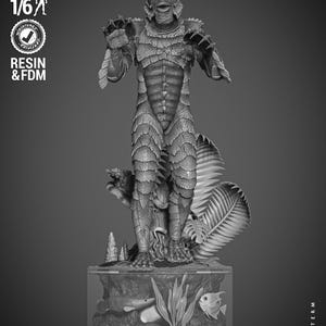 May include: A 1/6 scale gray resin figure of the Creature from the Black Lagoon standing on a base with aquatic plants and fish. The figure features textured scales, webbed hands, and a detailed head. Text on the base reads Creature from the Black Lagoon.