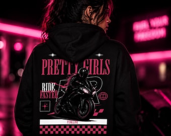 May include: Black hoodie with the text "PRETTY GIRLS RIDE FASTER" in pink. The graphic features a motorcycle and a rider. The bottom of the hoodie has a pink and black checkered pattern.