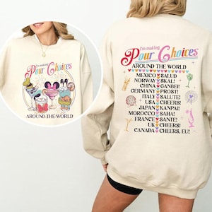 May include: Cream-colored sweatshirt with the text "I'm making Pour Choices" and a graphic of cocktails. The back of the sweatshirt has a list of countries and their respective cheers, including Mexico, Norway, China, and Germany.