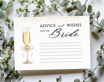 May include: A white card with the text "ADVICE and WISHES FOR THE Bride" and lined spaces for writing. A champagne glass with a cream bow is on the left. The card is surrounded by green leaves.