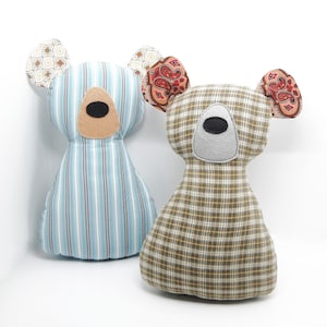 May include: Two handmade plush toy bears. One bear is blue and white striped with paisley fabric ears. The other bear is brown and tan plaid with paisley fabric ears.