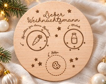 Op de afbeelding: Een ronde houten plank gegraveerd met de Duitse tekst 'Lieber Weihnachtsmann', 'Karotten für deine Rentiere', 'Milch' en 'Kekse'. Het ontwerp bevat iconen van een wortel, een melkfles en een koekje, omringd door kleine sterretjes.