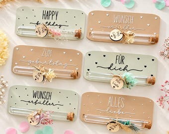 May include: Six rectangular plaques in sage green and tan featuring glass test tubes with cork stoppers. Each plaque displays text such as Happy Birthday, Wunsch Erfüller, Zum Geburtstag, Für Dich, and Alles Liebe, accented with dried flowers and small wooden tags.
