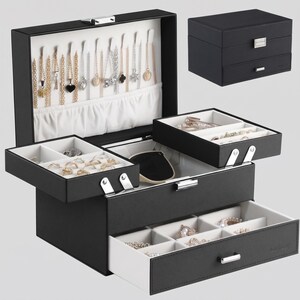 May include: A black jewellery box with a white interior, featuring a hinged lid with necklace hooks and a pouch, two tiered pull-out trays with ring and earring compartments, and a bottom drawer. The exterior has a silver metal latch and handle.