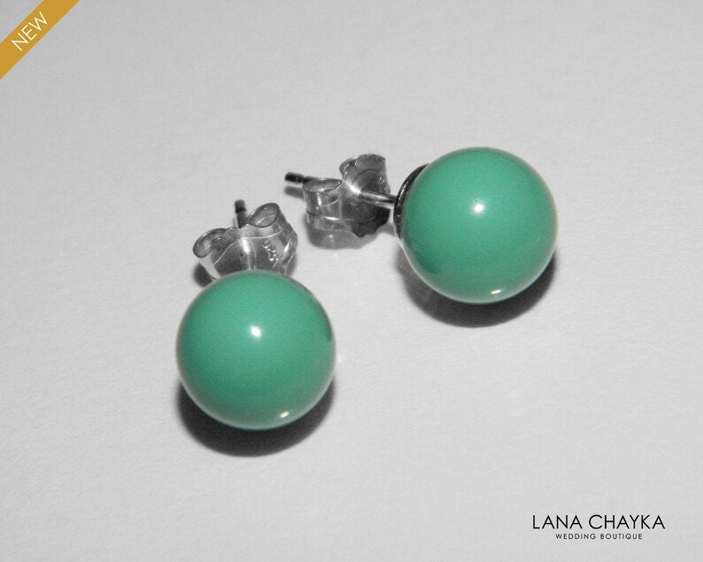 May include: A pair of silver stud earrings with turquoise round stones.