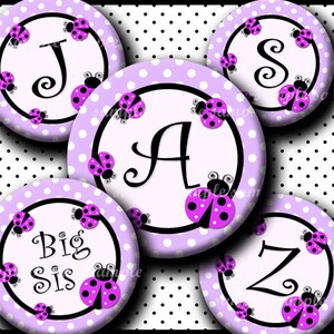 May include: Six purple and white polka dot circles with black outlines. Each circle has a black letter in the center, J, A, Z, S, and the words "Big Sis". Each circle has a black ladybug with pink spots on it.