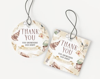 May include: Two baby shower thank you tags with a watercolor design. One is round, the other square. Both feature text that reads "Thank You For Showering Our Baby! Love, Sophia" with illustrations of a sorting hat, owl, and other magical elements.