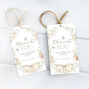 May include: Two white gift tags with a floral design and the words "thank you" in script. The tags feature illustrations of butterflies, bunnies, and squirrels. Each tag has a twine string for hanging.
