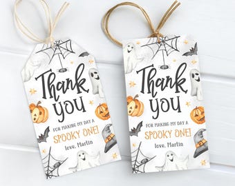 May include: Two Halloween-themed gift tags with a watercolor design. Each tag features a spider web, bats, ghosts, pumpkins, and a witch's hat. The text reads "Thank you" and "For making my day a spooky one!" with a name.