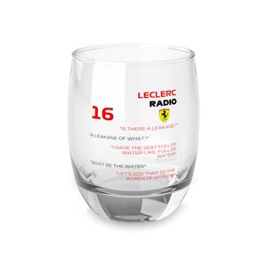 May include: A clear, stemless glass with the number 16 in red, the words "LECLERC RADIO", and the Ferrari logo. The glass features several quotes in white text, including "IS THERE A LEAKAGE?" and "MUST BE THE WATER".