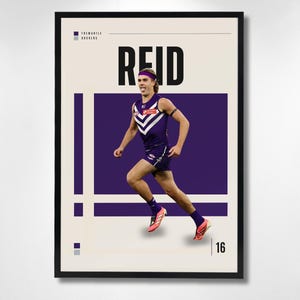 May include: A framed poster featuring a graphic of an athlete in a purple Fremantle Dockers uniform running. The text REID is printed in large black letters above the athlete, with the number 16 in the bottom right corner and team branding.