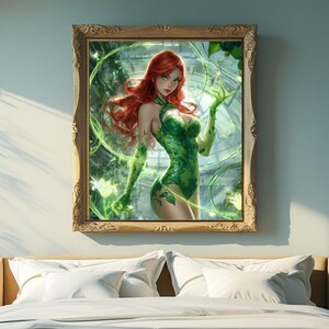 May include: A framed art print featuring a woman with red hair and a green costume, surrounded by green vines and glowing effects. The artwork is displayed in a bedroom setting, above a bed with white bedding.