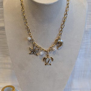 Gold-plated steel necklace with shell charms