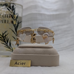 Steel bracelet with gold charms