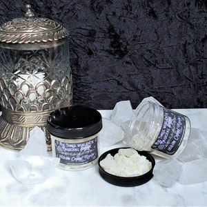 May include: Two glass jars filled with white copal resin. The jars have black lids and labels that read "The Three Wise Cats Mystical Store" and "White Copal Resin".