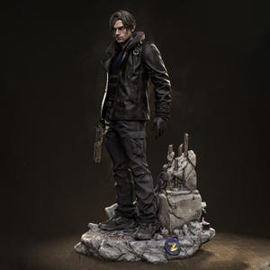 May include: A detailed figurine of a character in a black leather jacket, dark pants, and gloves, holding a gun. The figure stands on a rocky base with a stylized emblem. The character has short, styled hair and a serious expression.