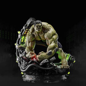 May include: A detailed Hulk statue in a dynamic pose, with a green muscular physique. The figure is set on a rocky base with glowing green accents and a futuristic, circular structure behind it. The overall colour scheme is green, black, and grey.