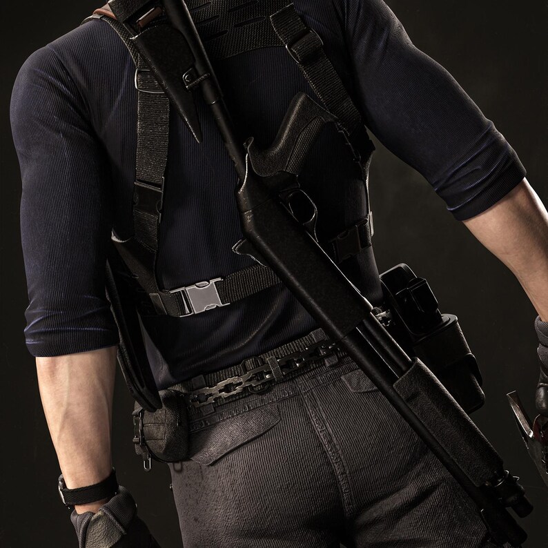 May include: A black shotgun is slung over the shoulder of a person wearing a dark blue long-sleeve shirt and tactical gear. The person is also wearing a black belt and gray pants. The background is dark.