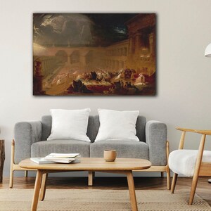 May include: A framed print of an antique painting depicting a dramatic scene with figures, arches, and columns under a dark, stormy sky. The artwork is displayed above a gray sofa with white pillows, enhancing the room's decor.