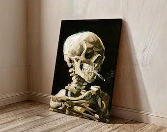 May include: A canvas print of a skull smoking a cigarette, set against a black background. The artwork features a detailed depiction of the skull's bone structure, with a lit cigarette in its mouth. The painting is leaning against a light-colored wall.