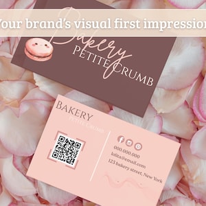 May include: Two business cards for a bakery, "Petite Crumb," rest on a bed of pink and white rose petals. One card is brown with the bakery's name and a macaron illustration. The other is pink with contact info and a QR code.