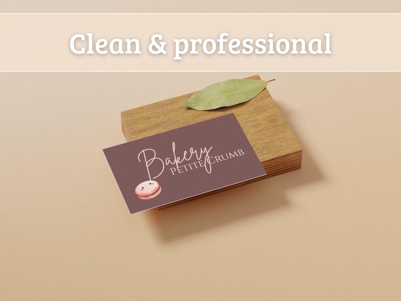 May include: A business card for "Bakery Petite Crumb" with a watercolor macaron illustration. The card is on a wooden block, with a leaf on top. The text "Clean & professional" is at the top.