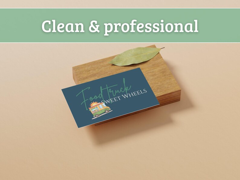 May include: A business card with the text "Food Truck Sweet Wheels" and a food truck illustration, resting on a wooden block. A green leaf sits on top of the block. The words "Clean & professional" are at the top.