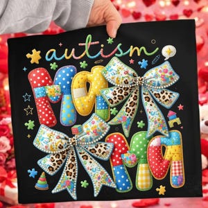 May include: Black square with the word "autism" in colorful letters. The letters are decorated with bows, polka dots, and floral patterns. The image has a handmade, patchwork style.