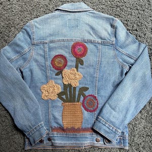 Up Cycled, Denim Jacket Embellished with a Base of Flowers Using Repurposed Materials