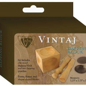 May include: A wooden dapping block with two wooden dapping punches. The block measures 2.25 inches by 2.25 inches by 2.25 inches. The set is packaged in a brown box with the brand name "VINTAJ" printed on it.