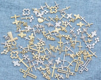 May include: A collection of small, decorative crosses in various designs and sizes. The crosses are in gold and silver tones, with some featuring intricate details. The assortment includes openwork, solid, and stylized cross shapes, suitable for jewelry making or craft projects.
