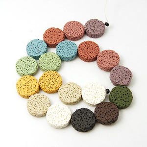 May include: A strand of round, lava rock beads in various colors, including green, blue, yellow, brown, white, and purple. The beads are strung on a white cord.
