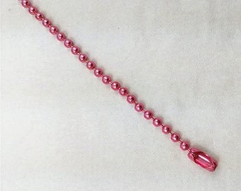 May include: A pink metal chain with round links. The chain is approximately 12 inches long.