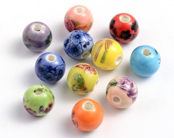 May include: Assortment of 10 ceramic beads with various floral patterns. The beads are in shades of blue, green, yellow, orange, red, and purple. Each bead has a hole in the center for stringing.