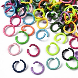 May include: Assortment of colorful metal jump rings in various sizes. The jump rings are made of metal and have a polished finish. They are perfect for jewelry making, crafting, and other DIY projects.