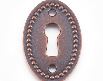 May include: Oval-shaped, antique bronze keyhole cover with a beaded border. The cover features a keyhole opening and two small screw holes. The metal has a distressed finish, giving it a vintage appearance. Ideal for furniture restoration or decorative projects.