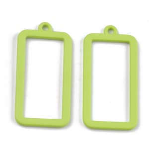 May include: Two lime green rectangular metal frames with a hole at the top for hanging.