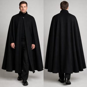 May include: A floor-length black wool cape featuring a high collar, a single button closure at the neck, and a full, flowing silhouette. The garment is shown from both the front and back views, displaying a smooth, solid black fabric texture.
