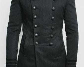 May include: A black military-style coat with a high collar and double-breasted button closure. The coat features decorative shoulder epaulettes and button details on the sleeves. The coat is a long, tailored design.